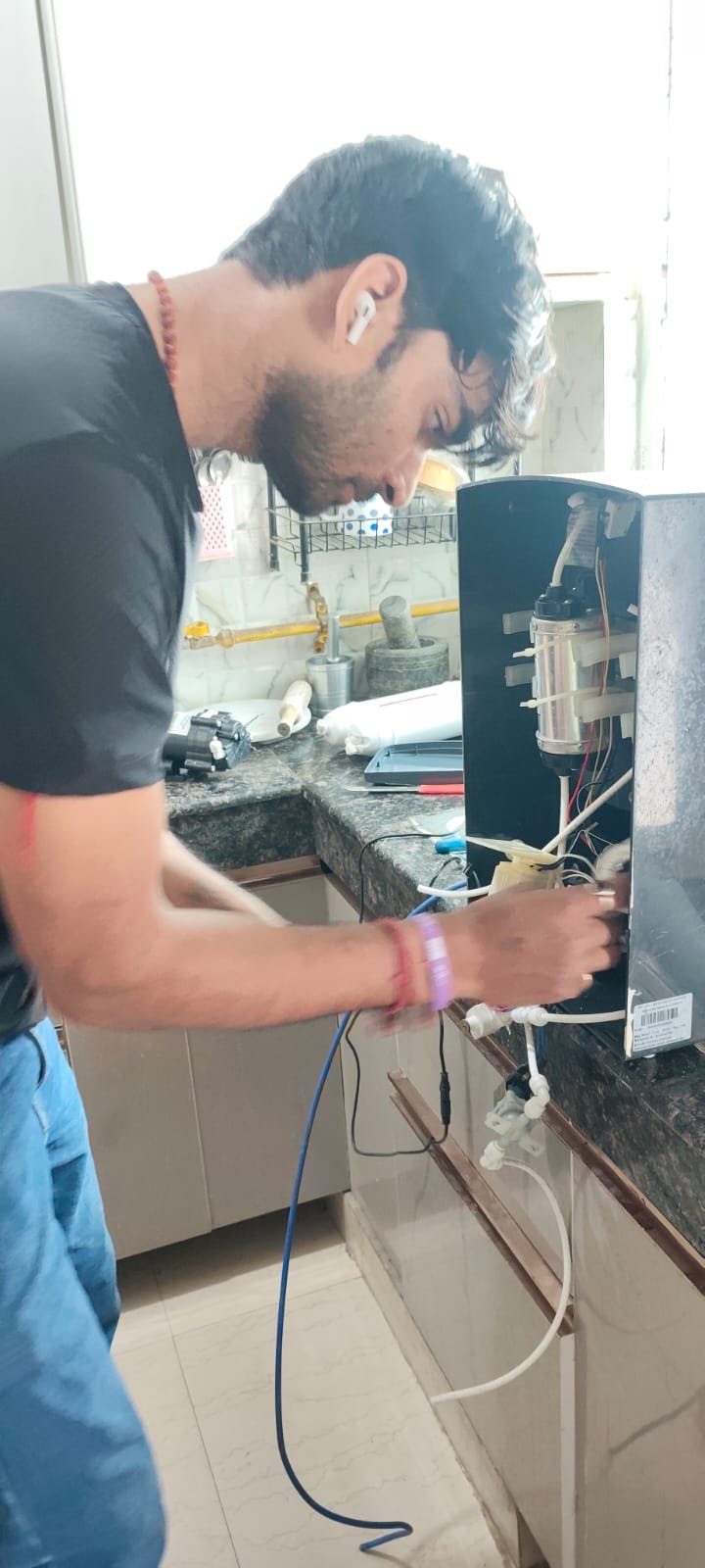 RO technician repairing a purifier at customer home